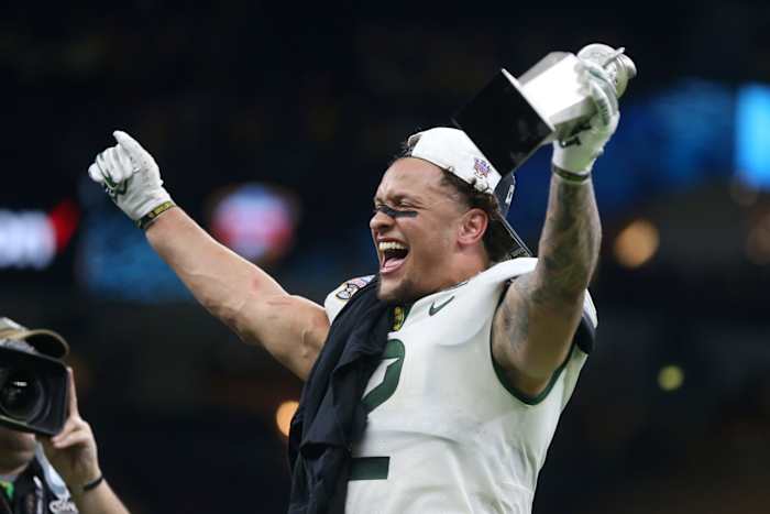 Jan 1, 2022; New Orleans, LA, USA; Sugar Bowl MVP Baylor Bears linebacker Terrel Bernard (2) reacts while holding his trophy after defeating the Mississippi Rebels in the 2022 Sugar Bowl at the Caesars Superdome. Baylor won 21-7.